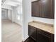 Elegant dining area featuring a granite countertop, dark cabinets, and natural lighting at 2910 Blake Towers Ln, Buford, GA 30519