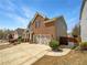 Two-story home featuring a brick facade, attached garage, and manicured landscaping at 2910 Blake Towers Ln, Buford, GA 30519