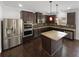 Modern kitchen boasts stainless steel appliances, a center island, and dark hardwood floors at 2910 Blake Towers Ln, Buford, GA 30519