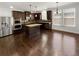 Gourmet kitchen with stainless steel appliances, center island, dark cabinets and hardwood floors at 2910 Blake Towers Ln, Buford, GA 30519