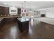 Open concept kitchen with dark cabinetry, granite counters, and stainless steel appliances at 2910 Blake Towers Ln, Buford, GA 30519
