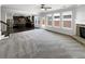 Open-concept living space featuring a kitchen, fireplace, and large windows with backyard views at 2910 Blake Towers Ln, Buford, GA 30519