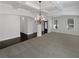The living room has neutral carpet, a dark wood floor entryway, a decorative light fixture and white walls at 2910 Blake Towers Ln, Buford, GA 30519