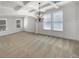 This living room has neutral colored carpeting, white walls, a decorative light fixture, and natural light at 2910 Blake Towers Ln, Buford, GA 30519