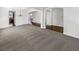 This living room has neutral colored carpeting, white walls, dark wood floors, and a decorative light fixture at 2910 Blake Towers Ln, Buford, GA 30519
