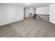 Open loft area featuring neutral carpeting, white walls, and decorative wrought iron railing at 2910 Blake Towers Ln, Buford, GA 30519