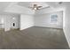 Bright main bedroom featuring tray ceilings, neutral walls, a ceiling fan, and plush carpeting at 2910 Blake Towers Ln, Buford, GA 30519
