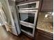 Modern kitchen features stainless steel double ovens and a granite countertop at 2910 Blake Towers Ln, Buford, GA 30519