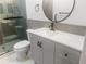 Elegant bathroom featuring modern vanity with matte black hardware, circular mirror and sleek fixtures at 475 Mount Vernon Ne Hwy # 226C, Atlanta, GA 30328