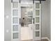 Bathroom entrance featuring sliding doors and a modern vanity with a round mirror at 475 Mount Vernon Ne Hwy # 226C, Atlanta, GA 30328