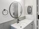 Updated bathroom vanity with matte black faucet, round mirror, and neutral paint at 475 Mount Vernon Ne Hwy # 226C, Atlanta, GA 30328
