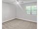 A cozy bedroom with neutral carpet, ceiling fan, and a window with blinds for natural light at 475 Mount Vernon Ne Hwy # 226C, Atlanta, GA 30328