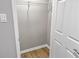 A well-lit, empty closet with wooden floors and a metal hanging rod is ready for storage at 475 Mount Vernon Ne Hwy # 226C, Atlanta, GA 30328