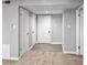 Hallway featuring two doors and laminate wood flooring at 475 Mount Vernon Ne Hwy # 226C, Atlanta, GA 30328