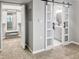 Hallway showcasing a walk-in closet and bathroom with a sliding door, all in neutral tones at 475 Mount Vernon Ne Hwy # 226C, Atlanta, GA 30328