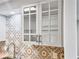 Close-up of kitchen cabinets with glass doors and modern hardware above the sink at 475 Mount Vernon Ne Hwy # 226C, Atlanta, GA 30328