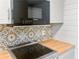 Modern kitchen featuring stainless steel appliances, wooden countertop, and decorative backsplash at 475 Mount Vernon Ne Hwy # 226C, Atlanta, GA 30328