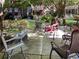 Beautiful outdoor patio seating area surrounded by mature trees and landscaping at 475 Mount Vernon Ne Hwy # 226C, Atlanta, GA 30328