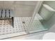 This shower features decorative tiled flooring, sleek glass doors, and a convenient built-in bench at 475 Mount Vernon Ne Hwy # 226C, Atlanta, GA 30328