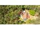 Aerial view of a secluded home surrounded by lush greenery, showcasing the property's privacy at 1791 Walker Sw Rd, Conyers, GA 30094