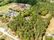 Secluded home aerial view surrounded by lush trees near school and community amenities at 1791 Walker Sw Rd, Conyers, GA 30094