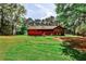 The backyard features a large red deck, perfect for outdoor living and entertaining at 1791 Walker Sw Rd, Conyers, GA 30094