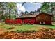 The backyard has a red deck and lush green grass to make it an outdoor oasis at 1791 Walker Sw Rd, Conyers, GA 30094