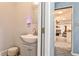 Bathroom with pedestal sink and door to living area at 1791 Walker Sw Rd, Conyers, GA 30094