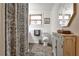 Bathroom with patterned shower curtain and shiplap walls, complemented by a vintage-style vanity at 1791 Walker Sw Rd, Conyers, GA 30094