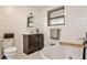 Bright bathroom with white shiplap walls, tub, toilet, vanity, and dark brown cabinets at 1791 Walker Sw Rd, Conyers, GA 30094