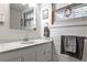 Bright bathroom featuring a marble countertop vanity and ample natural light from the window at 1791 Walker Sw Rd, Conyers, GA 30094
