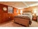 Bedroom with wood-paneled walls, a cozy bed, and soft lighting; offering a warm, inviting atmosphere at 1791 Walker Sw Rd, Conyers, GA 30094