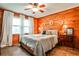 Wood paneled bedroom with warm lighting and natural light featuring a bed with neutral bedding at 1791 Walker Sw Rd, Conyers, GA 30094