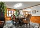 Dining room featuring wood paneling, a bay window, and a decorative rug at 1791 Walker Sw Rd, Conyers, GA 30094