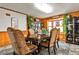 Dining room featuring a wooden table, six upholstered chairs, and wood paneling at 1791 Walker Sw Rd, Conyers, GA 30094