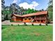 Inviting log home with a covered front porch and spacious green lawn at 1791 Walker Sw Rd, Conyers, GA 30094