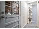 Hallway with gray door, display shelves, and tile floor at 1791 Walker Sw Rd, Conyers, GA 30094