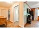 Hallway featuring tile floors, white trim, and a doorway leading to another room with a wood paneled wall at 1791 Walker Sw Rd, Conyers, GA 30094