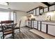 Eat-in kitchen featuring modern appliances, white cabinetry, and stylish dining area at 1791 Walker Sw Rd, Conyers, GA 30094