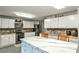 Bright, airy kitchen features white cabinets, stainless steel appliances, and a spacious island at 1791 Walker Sw Rd, Conyers, GA 30094