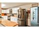Well-lit kitchen features stainless steel appliances, ample white cabinetry, and butcher block countertops at 1791 Walker Sw Rd, Conyers, GA 30094
