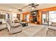 Spacious living room featuring hardwood walls, tile floors, a cozy fireplace, and a sliding door to the porch at 1791 Walker Sw Rd, Conyers, GA 30094