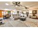 Open-concept living room with hardwood floors, ceiling fans, a dining table, and a kitchen area at 1791 Walker Sw Rd, Conyers, GA 30094