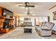 Spacious living room featuring hardwood walls, tile floors, a cozy fireplace, and a sliding door to the porch at 1791 Walker Sw Rd, Conyers, GA 30094