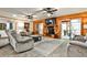 Spacious living room featuring hardwood walls, tile floors, a cozy fireplace, and a sliding door to the porch at 1791 Walker Sw Rd, Conyers, GA 30094
