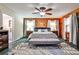 Bedroom with wood walls, ceiling fan, and connecting bathroom at 1791 Walker Sw Rd, Conyers, GA 30094