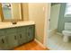 Well-lit bathroom with vanity, wood floor and tile surround shower at 1810 Talbot Ct, Lawrenceville, GA 30044