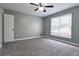 Spacious bedroom with gray walls, carpet flooring, and a ceiling fan at 1810 Talbot Ct, Lawrenceville, GA 30044