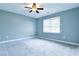 Bedroom with blue walls, carpet flooring, and a ceiling fan at 1810 Talbot Ct, Lawrenceville, GA 30044