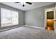 Bedroom with light gray walls, carpet flooring, ceiling fan, and closet at 1810 Talbot Ct, Lawrenceville, GA 30044